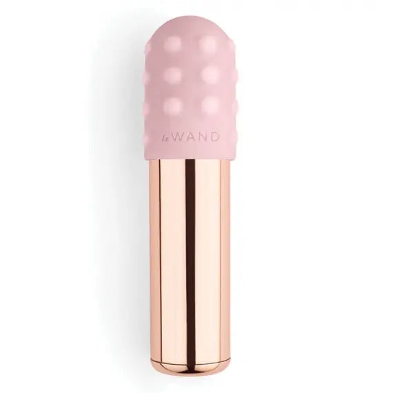 Cute rose gold le wand vibrating bullet is pictured against a white background with a removable silicone sleeve