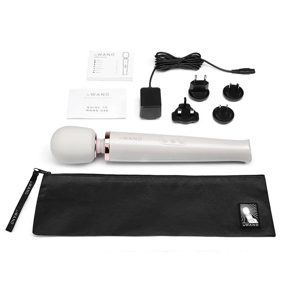 A white Le Wand Rechargeable massager, vibrator is pictured on a white background next to the case and charging cord