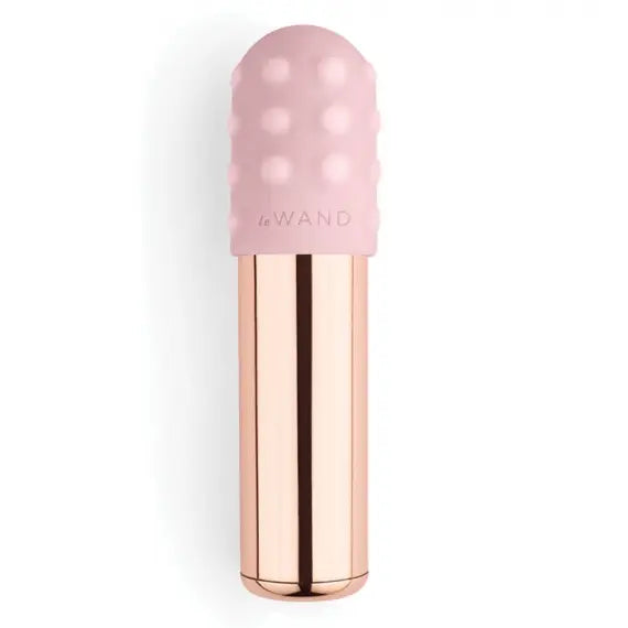 Cute rose gold le wand vibrating bullet is pictured against a white background with a removable silicone sleeve 