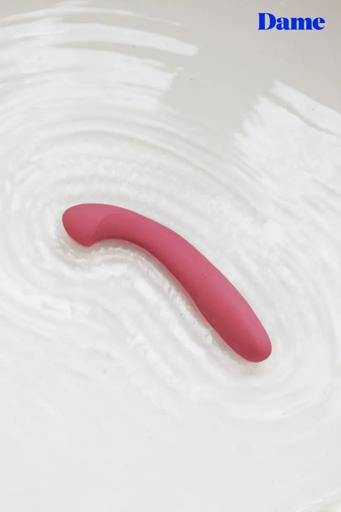 Arc, the G-spot vibrator is pictured in a pool of rippling water, showing that it is waterproof